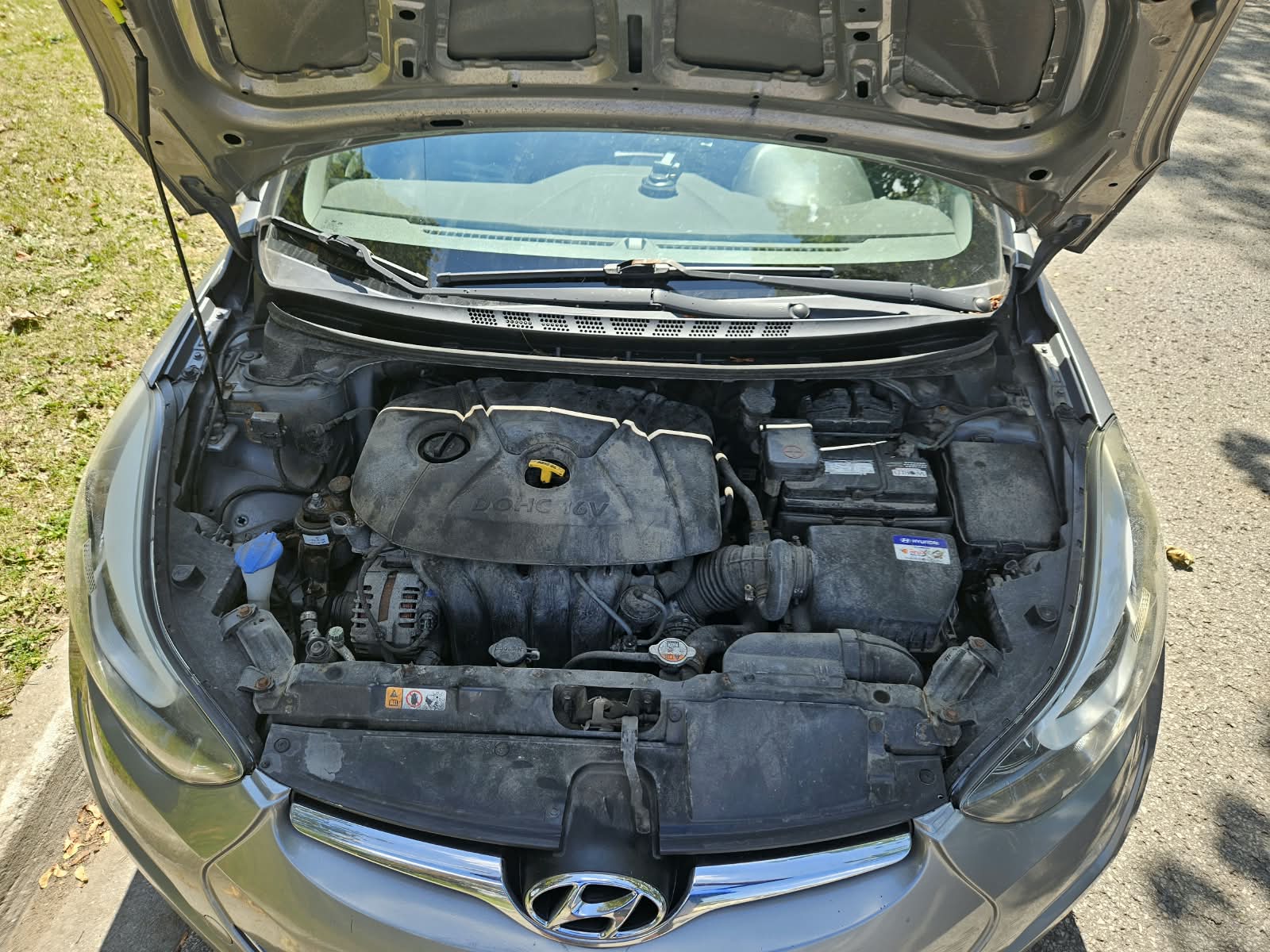 Engine bay of the 2016 Hyundai Elantra showing the 1.8L DOHC 16V engine