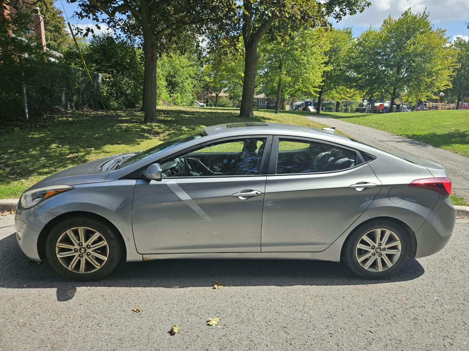 Silver-grey 2016 Hyundai Elantra side profile with alloy wheels and sunroof